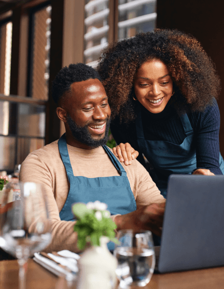Business owners reviewing repeat-customer follow-up
